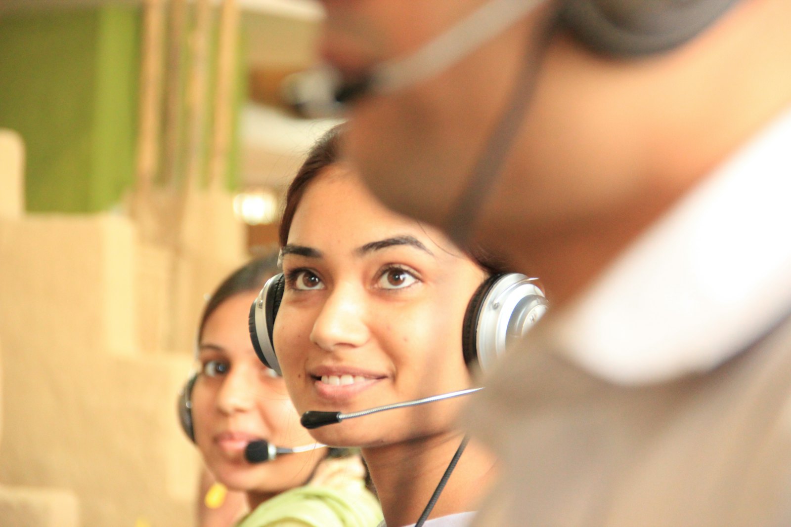 Call centre agents wearing headsets at their desks